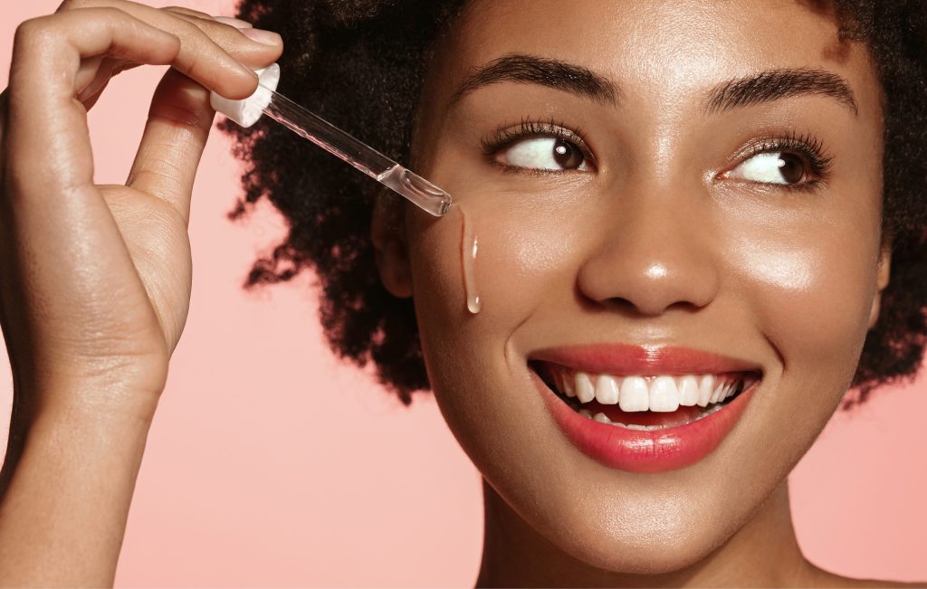 Serum being applied to glowing skin